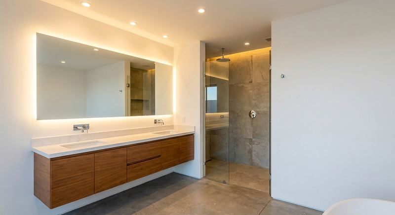 Backlit mirror and recessed lighting in a bathroom by Trini Homes in Gainesville FL