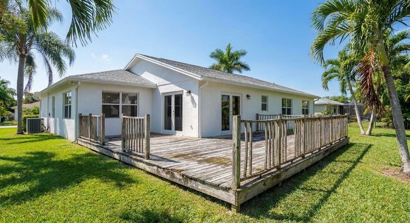 The same Gainesville home with a worn old wooden deck before Trini Homes work