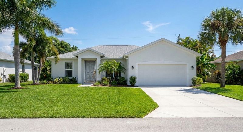 The same Gainesville home with a worn old front door before Trini Homes work