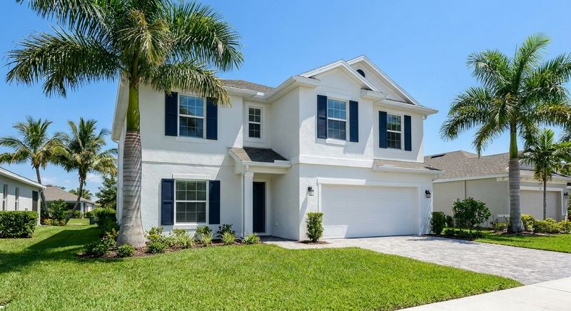 Freshly painted white Florida home with navy shutters by Trini Homes in Gainesville FL