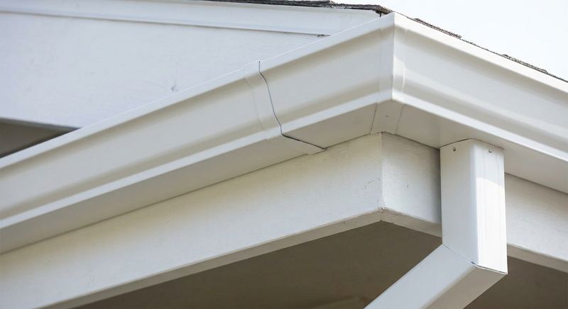 Clean white seamless aluminum gutters with hidden hangers installed by Trini Homes in Gainesville FL