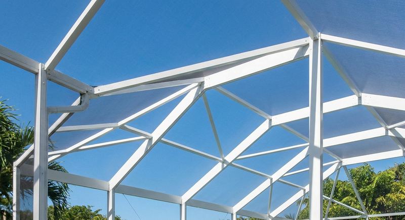 White aluminum enclosure trusses and beams over a pool cage